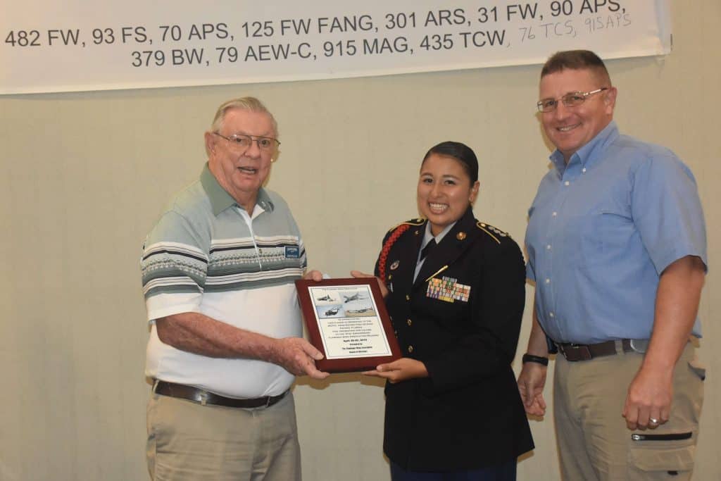 Herb and one other member presenting a plaque to a young lady of the JROTC at Estero High School, for presenting colors at the Reunion 2019.